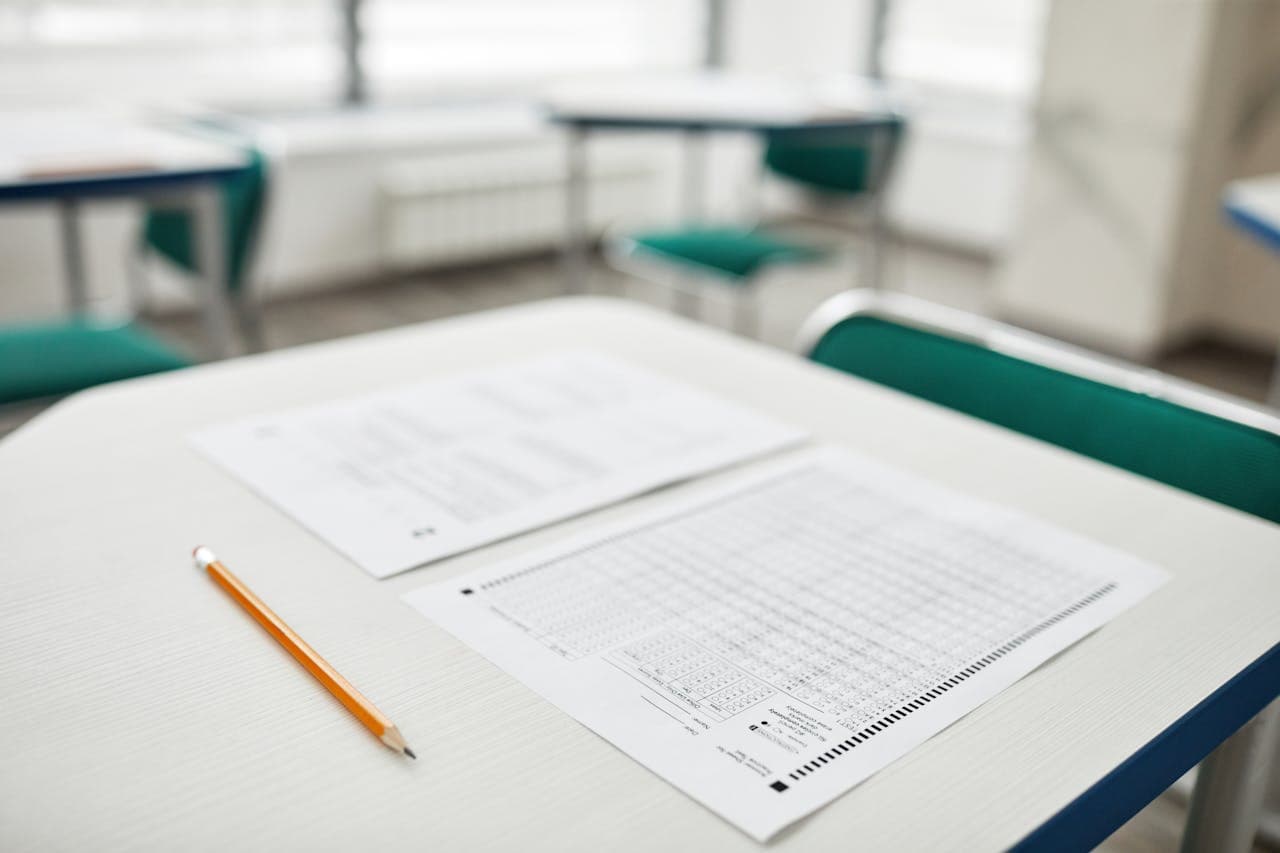 Test paper and pencil on a desk in an exam room