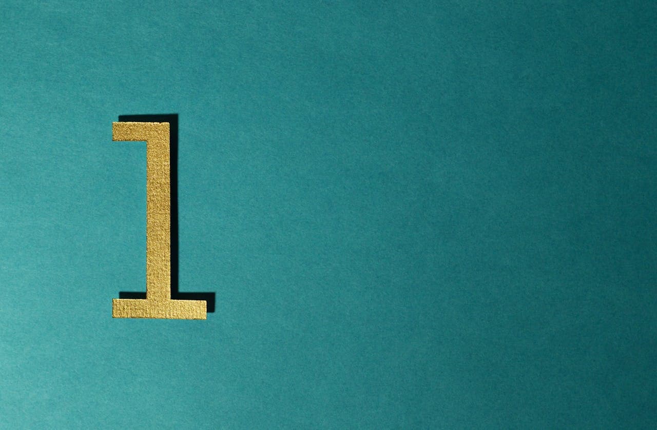 Gold number 1 freestanding decor on teal background